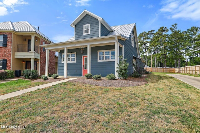 view of front of home with a balcony and a front lawn