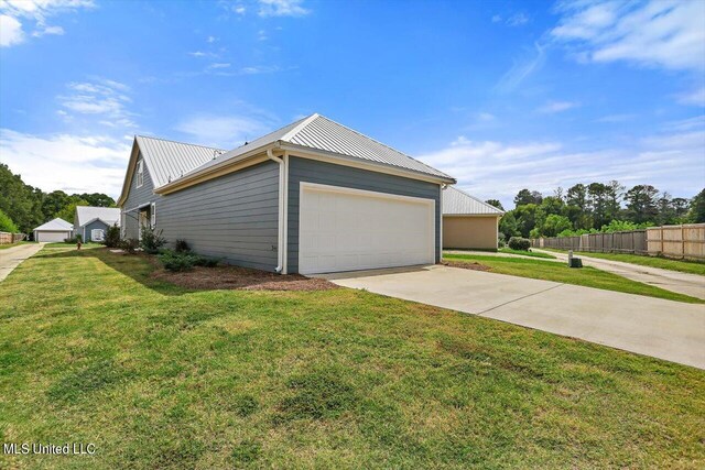 view of property exterior featuring a garage and a lawn