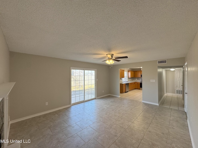 unfurnished living room featuring ceiling fan, a textured ceiling, and light tile patterned floors