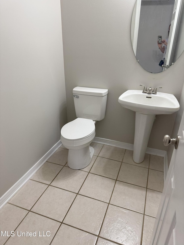 bathroom featuring tile patterned flooring, sink, and toilet