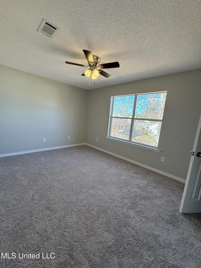 carpeted empty room with a textured ceiling and ceiling fan