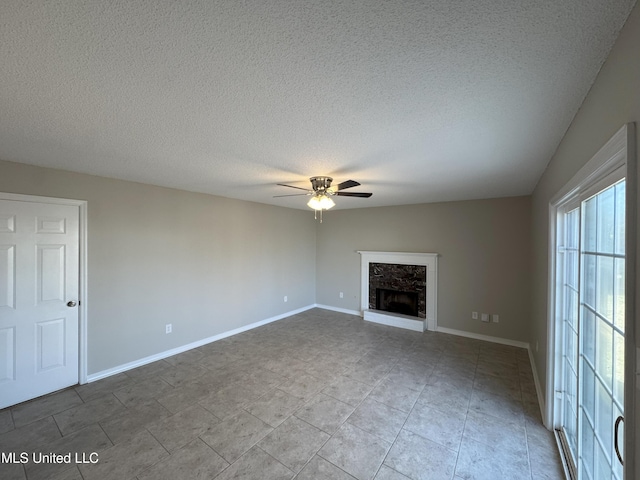 unfurnished living room featuring a textured ceiling and ceiling fan