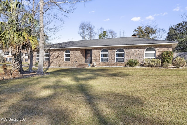 ranch-style home featuring brick siding and a front yard