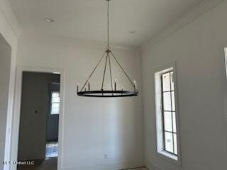 unfurnished dining area with crown molding and a healthy amount of sunlight