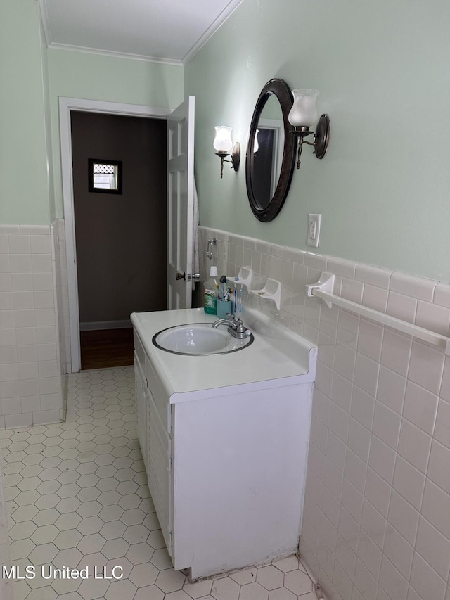 820 Ave Of Pines St, Grenada, MS 38901 - bathroom with tile walls, vanity, tile patterned floors, and ornamental molding