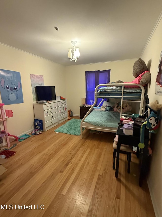 820 Ave Of Pines St, Grenada, MS 38901 - bedroom with an inviting chandelier, wood-type flooring, and crown molding