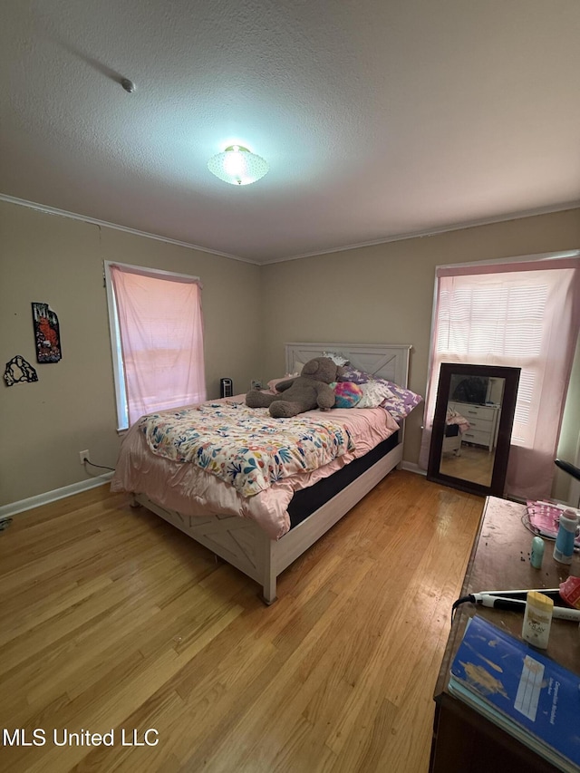 820 Ave Of Pines St, Grenada, MS 38901 - bedroom featuring light hardwood / wood-style floors and a textured ceiling