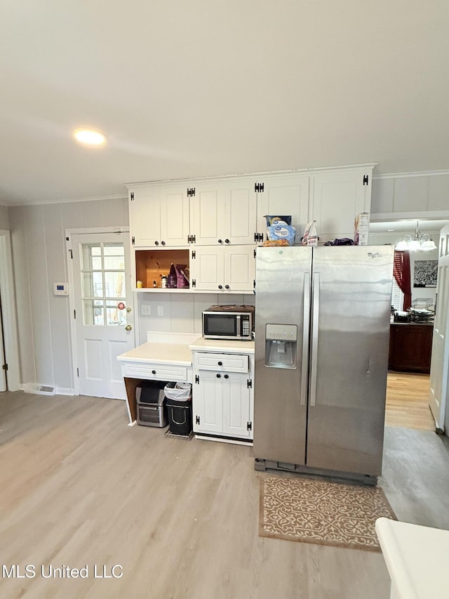 820 Ave Of Pines St, Grenada, MS 38901 - kitchen with white cabinetry, crown molding, light hardwood / wood-style flooring, and stainless steel appliances