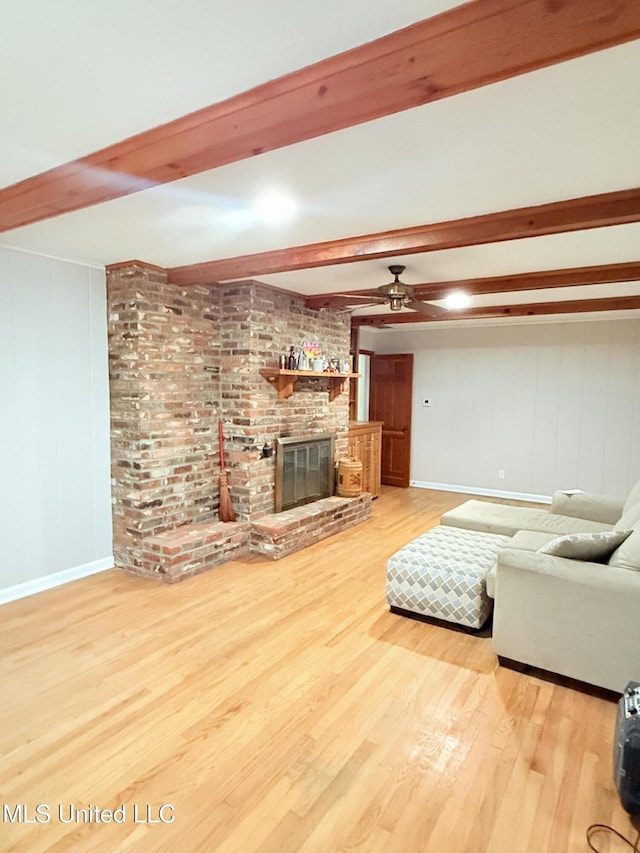 820 Ave Of Pines St, Grenada, MS 38901 - living room with hardwood / wood-style flooring, ceiling fan, beam ceiling, and a brick fireplace