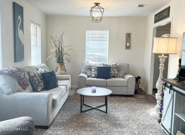 living room featuring an inviting chandelier and wood-type flooring