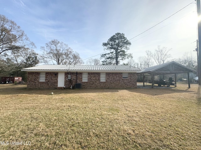 exterior space with a carport, a front lawn, and central air condition unit