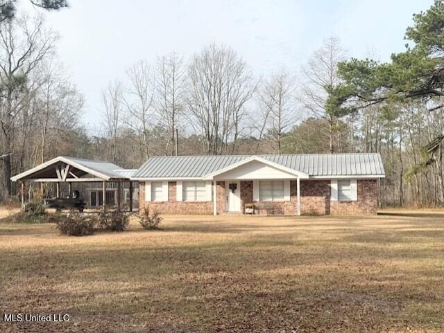 single story home featuring covered porch and a front lawn