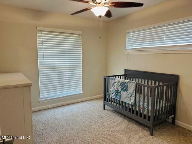 113 Richardson Rd, Picayune, MS 39466 - bedroom featuring carpet flooring, baseboards, a nursery area, and a ceiling fan