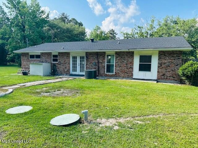 113 Richardson Rd, Picayune, MS 39466 - back of house featuring french doors, central air condition unit, a yard, and brick siding