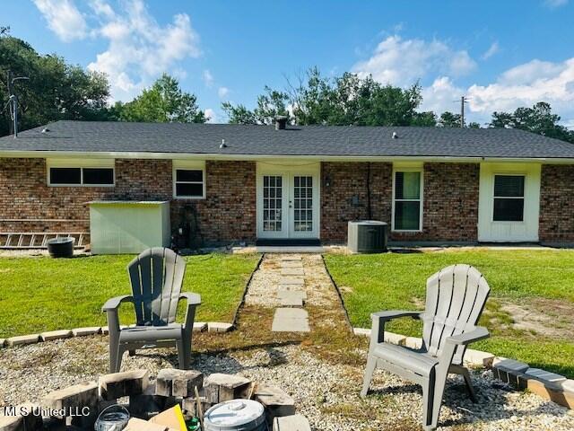 113 Richardson Rd, Picayune, MS 39466 - rear view of property featuring french doors, central air condition unit, brick siding, and a yard