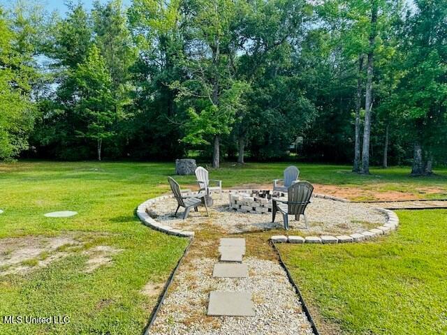 113 Richardson Rd, Picayune, MS 39466 - view of green lawn with an outdoor fire pit