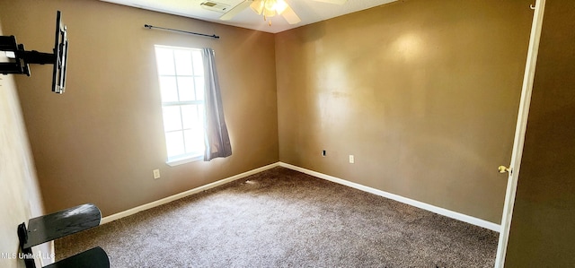 carpeted empty room featuring a wealth of natural light, baseboards, and ceiling fan
