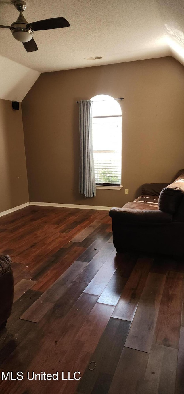 sitting room featuring wood finished floors, a ceiling fan, and vaulted ceiling