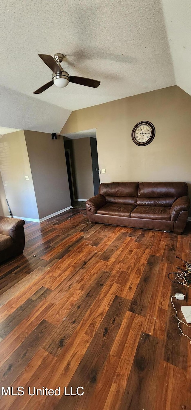 unfurnished living room with a ceiling fan, hardwood / wood-style flooring, and vaulted ceiling