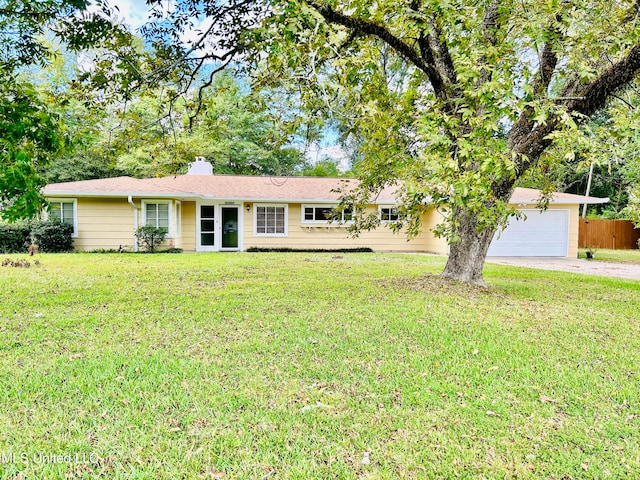 ranch-style home with a front yard and a garage