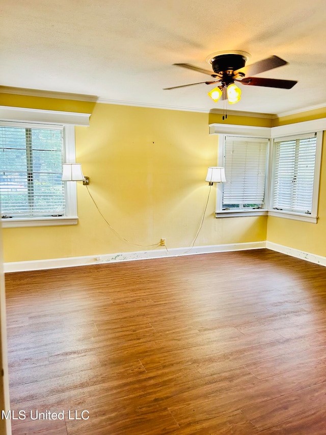 unfurnished room with ceiling fan, hardwood / wood-style flooring, and ornamental molding