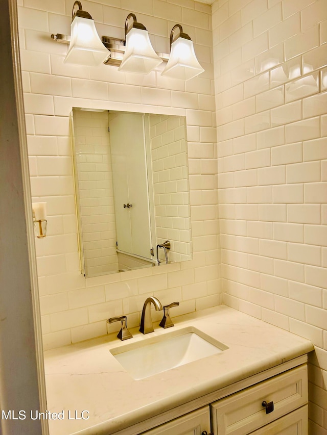 bathroom with vanity and backsplash