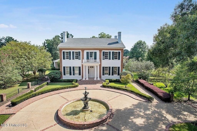 colonial inspired home featuring a balcony