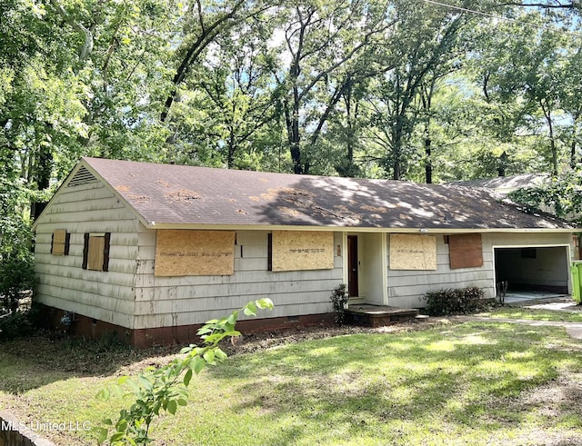 ranch-style house featuring a front yard, roof with shingles, an attached garage, and crawl space