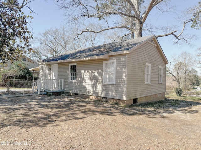 view of home's exterior with crawl space and fence