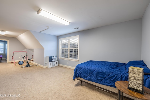 bedroom featuring lofted ceiling, baseboards, visible vents, and carpet flooring