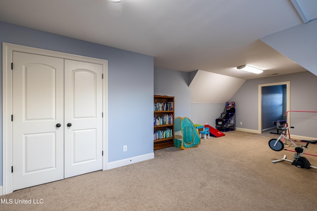 rec room with light colored carpet, vaulted ceiling, and baseboards