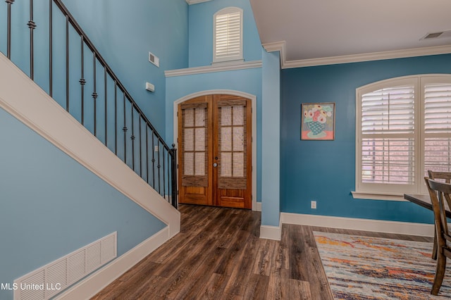 foyer featuring visible vents, dark wood-style floors, stairs, crown molding, and french doors