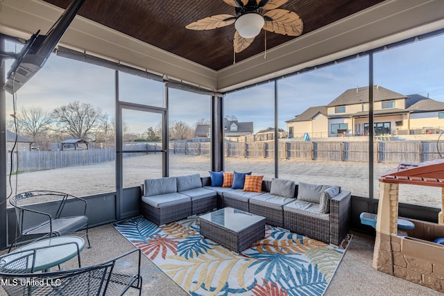 sunroom with wooden ceiling, plenty of natural light, a residential view, and a ceiling fan