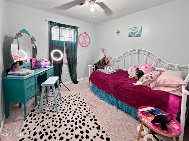 carpeted bedroom featuring a textured ceiling and ceiling fan