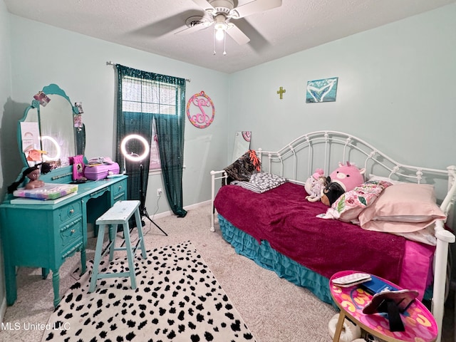 carpeted bedroom with a textured ceiling and ceiling fan