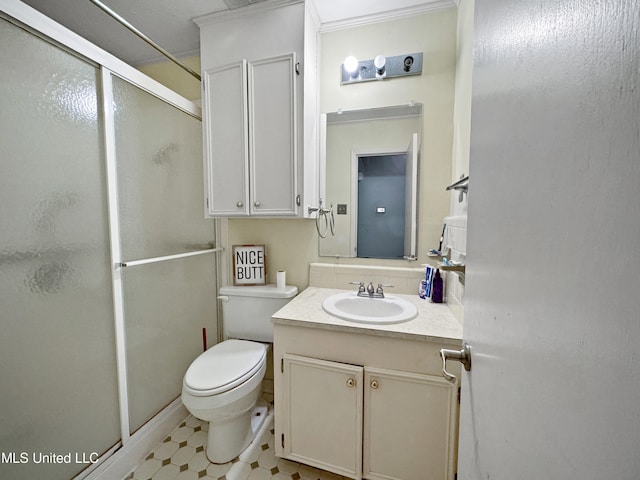 bathroom featuring toilet, an enclosed shower, and vanity