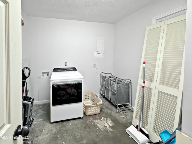 clothes washing area featuring washer / dryer and a textured ceiling