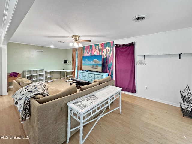 living room featuring wood-type flooring and ceiling fan