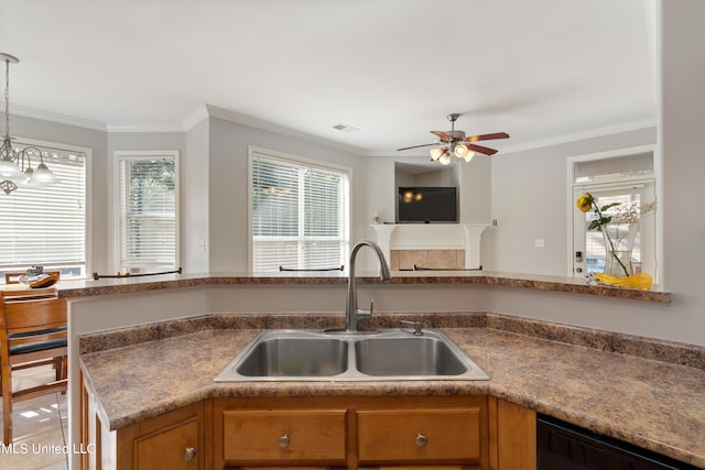 kitchen featuring black dishwasher, crown molding, sink, and decorative light fixtures