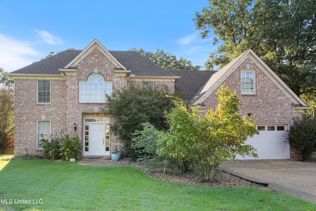 front facade featuring a front yard and a garage