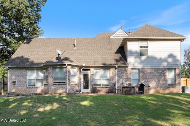 view of front of home featuring a front lawn and central AC unit