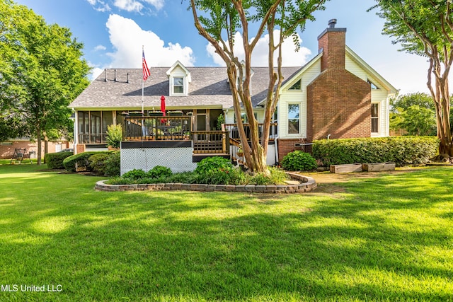 9194 Rosalie Cv, Olive Branch, MS 38654 - rear view of property featuring a sunroom, a yard, brick siding, a deck, and roof with shingles