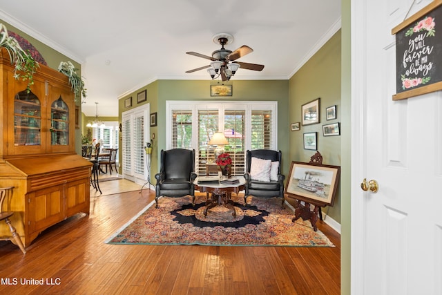 9194 Rosalie Cv, Olive Branch, MS 38654 - living area with hardwood / wood-style floors, plenty of natural light, ceiling fan, ornamental molding, and a chandelier