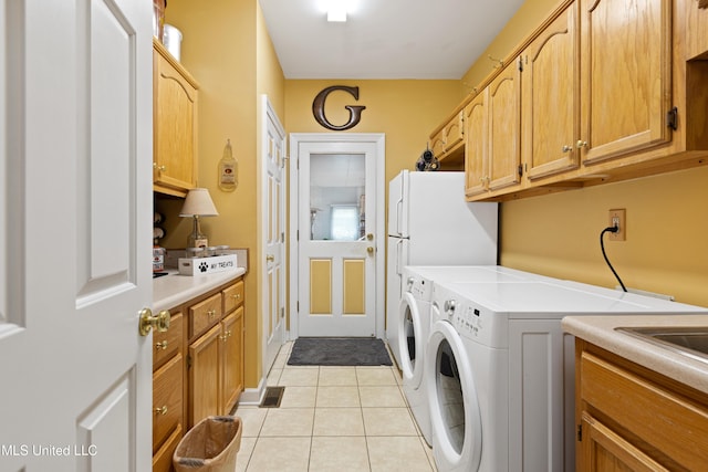 9194 Rosalie Cv, Olive Branch, MS 38654 - laundry room with light tile patterned flooring, washing machine and dryer, and cabinet space