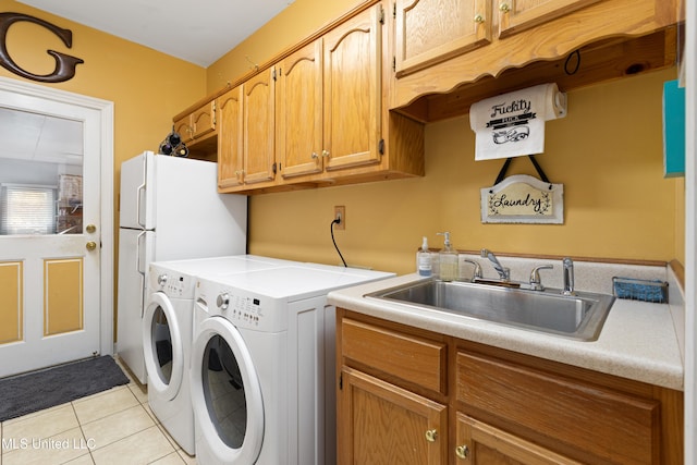 9194 Rosalie Cv, Olive Branch, MS 38654 - laundry area featuring light tile patterned floors, cabinet space, and independent washer and dryer