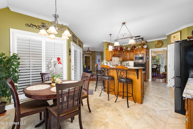 9194 Rosalie Cv, Olive Branch, MS 38654 - dining area with ornamental molding, a chandelier, light tile patterned flooring, and ceiling fan
