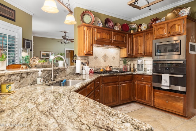 9194 Rosalie Cv, Olive Branch, MS 38654 - kitchen with stainless steel appliances, light stone countertops, backsplash, ornamental molding, and brown cabinets