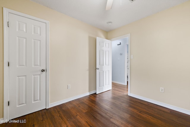 unfurnished bedroom featuring dark hardwood / wood-style floors and ceiling fan