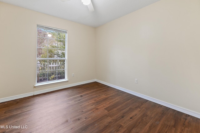 spare room featuring ceiling fan and dark wood-type flooring