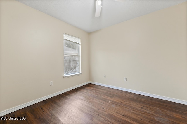 unfurnished room featuring ceiling fan and dark wood-type flooring